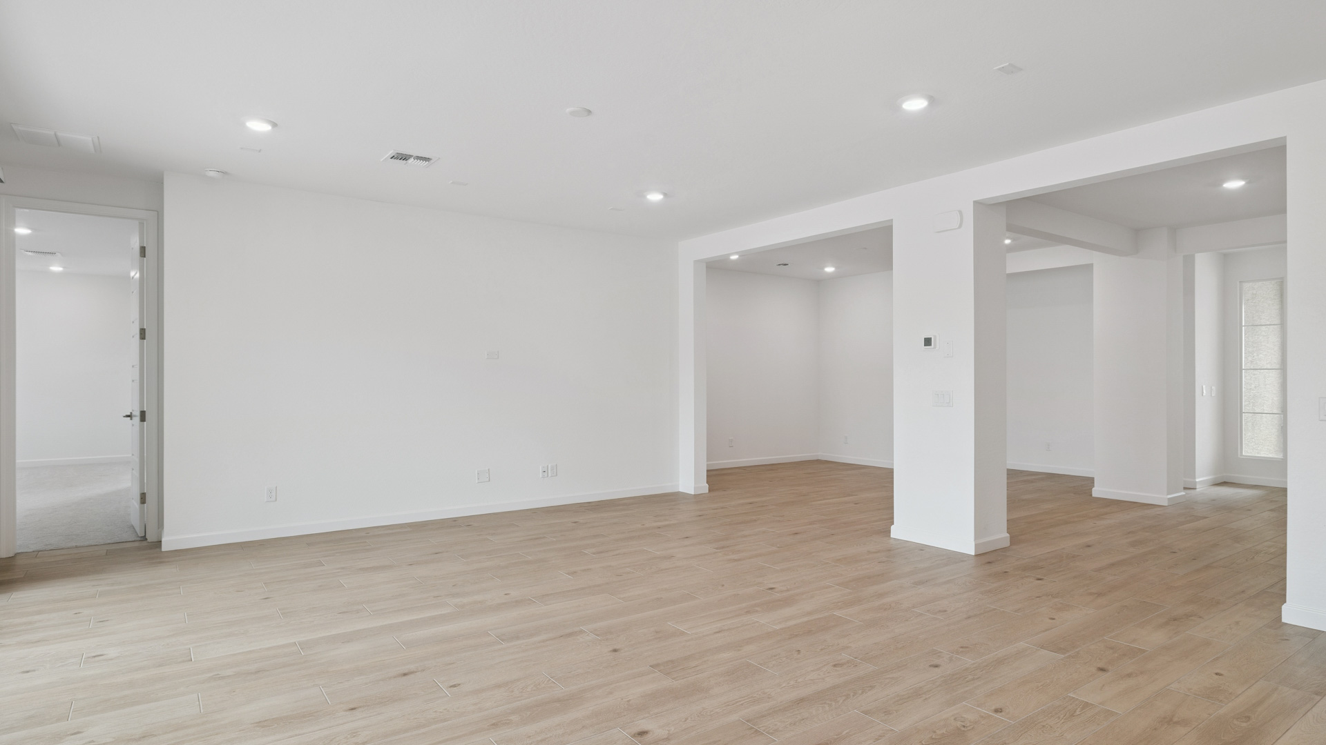 A well-organized living room that includes a kitchen and dining area, creating a warm and welcoming environment for gatherings.