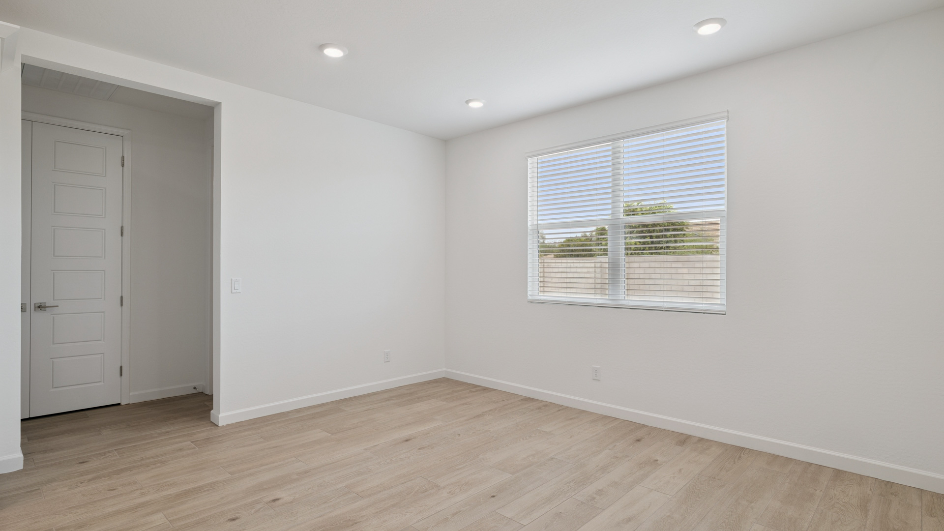A well-organized living room that includes a kitchen and dining area, creating a warm and welcoming environment for gatherings.