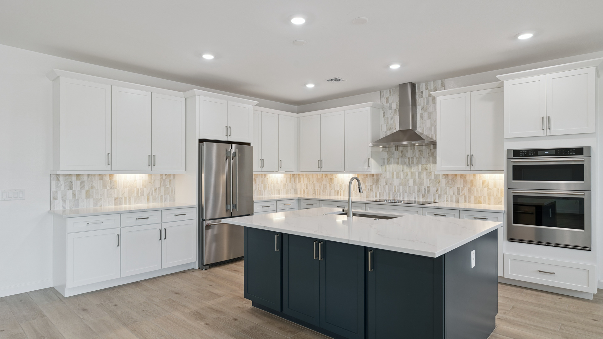 Bright and spacious kitchen with quartz countertops, stainless steel appliances, and an island with bar seating.