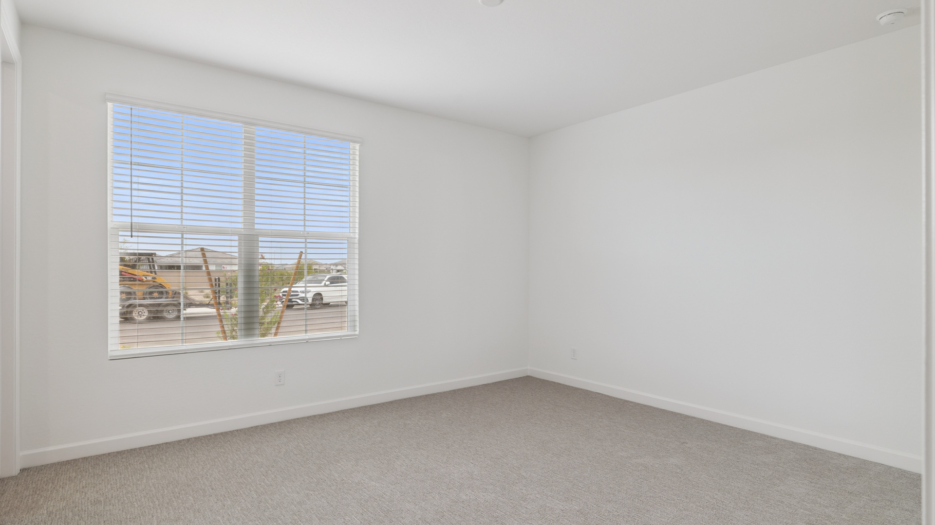 Comfortable guest bedroom featuring neutral-toned walls and a large closet.