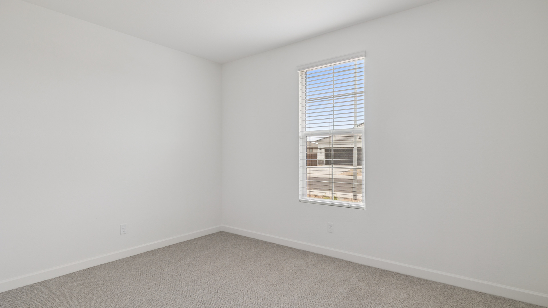 Comfortable guest bedroom featuring neutral-toned walls and a large closet.