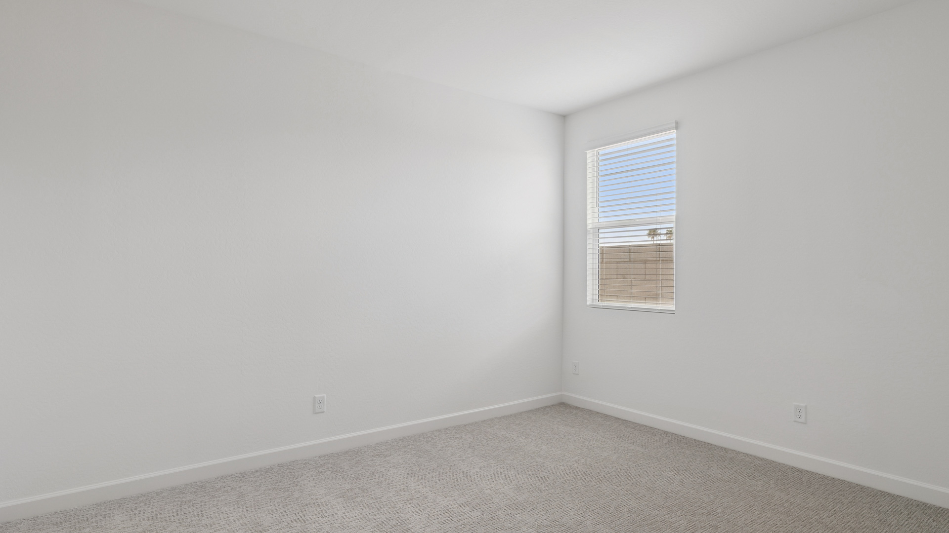 Comfortable guest bedroom featuring neutral-toned walls and a large closet.