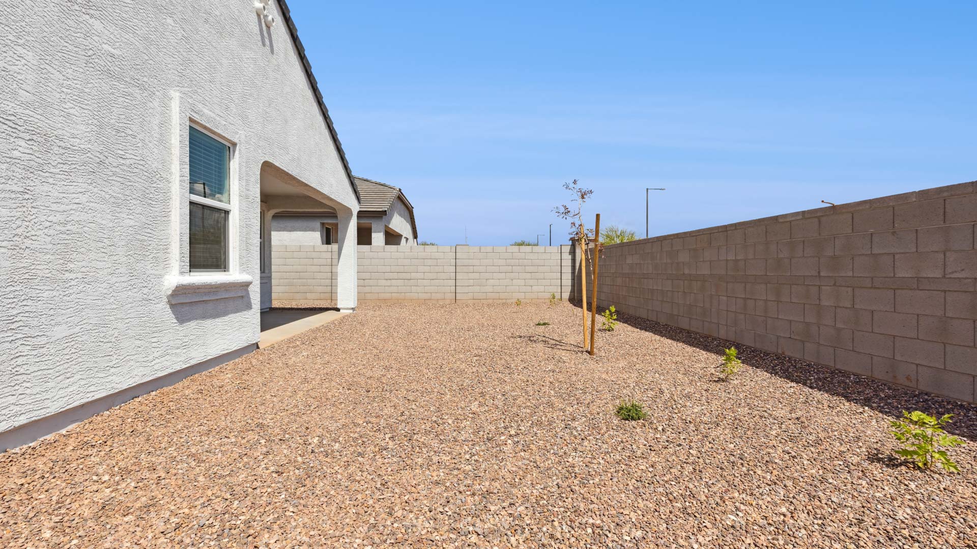 Large fenced-in backyard with a covered patio, perfect for outdoor entertainment.