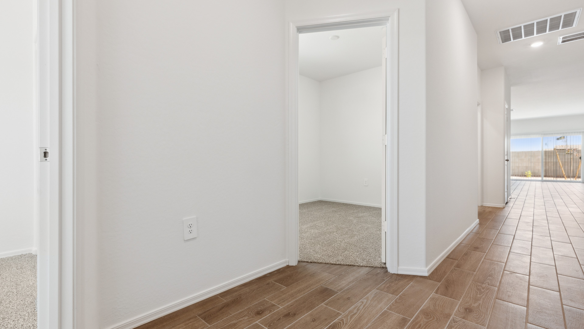 Entry hallway leading to bedrooms in the background.