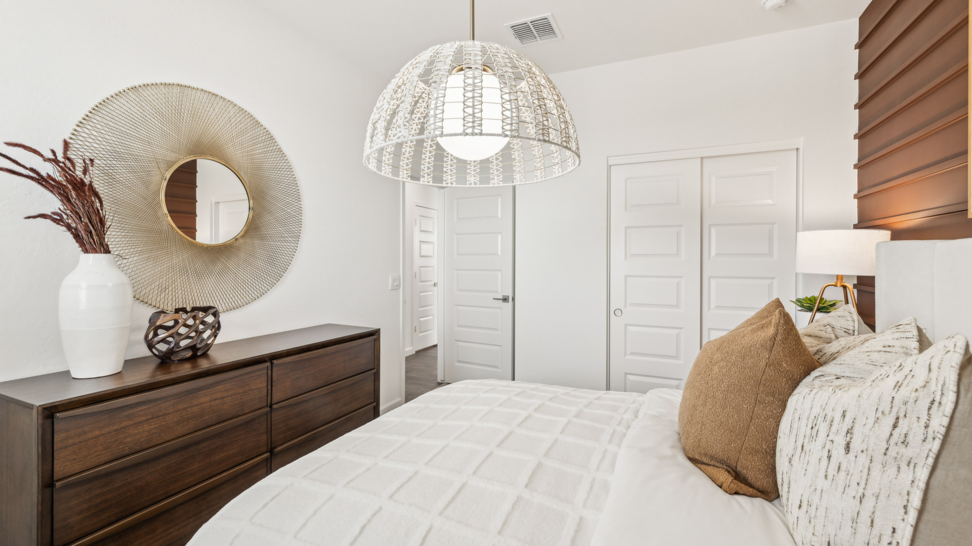 Comfortable guest bedroom featuring neutral-toned walls and a large closet.