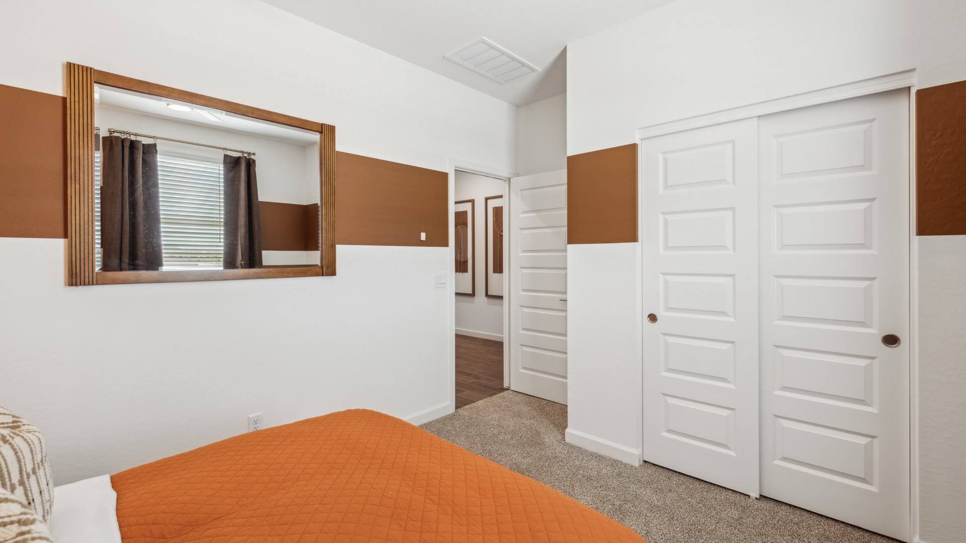 Comfortable guest bedroom featuring neutral-toned walls and a large closet.