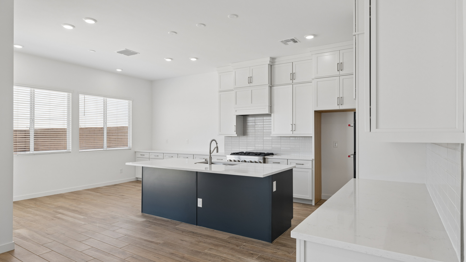 spacious kitchen with large island, walk in closet and floor to ceiling cabinets