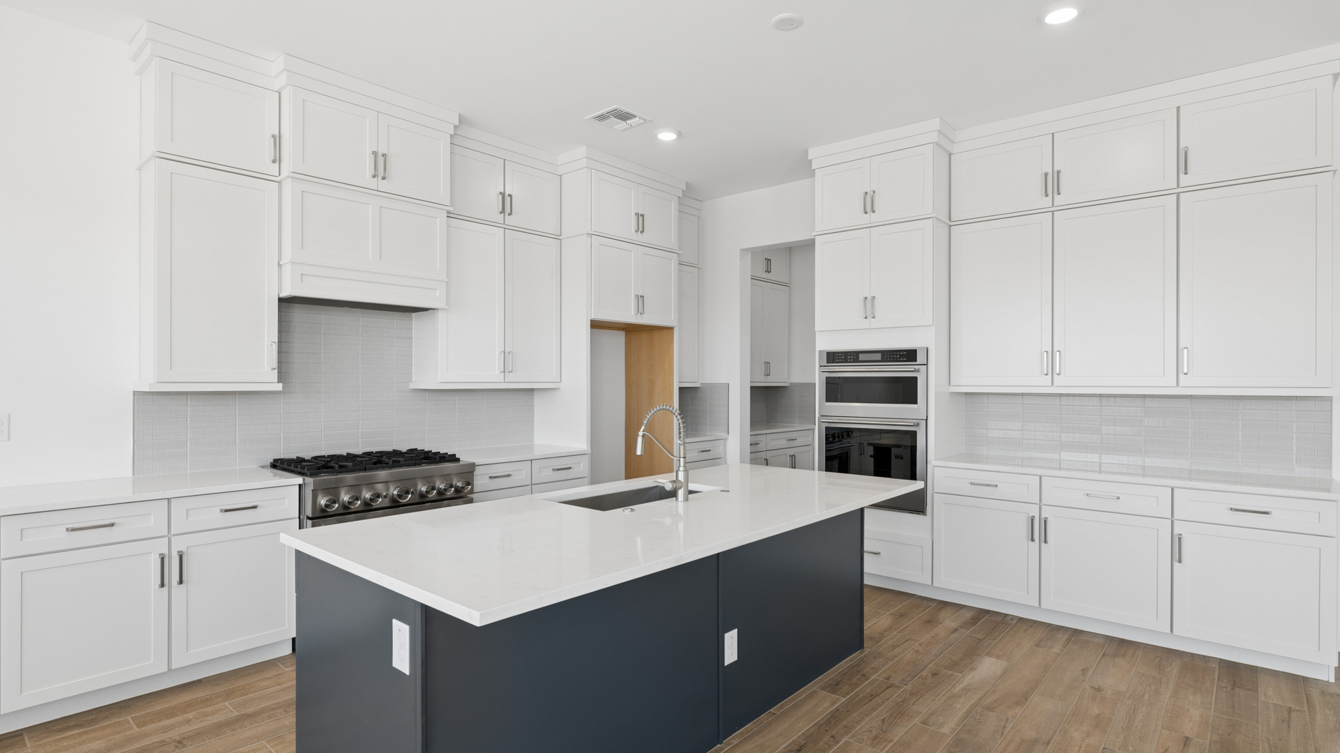 spacious kitchen with large island, walk in closet and floor to ceiling cabinets