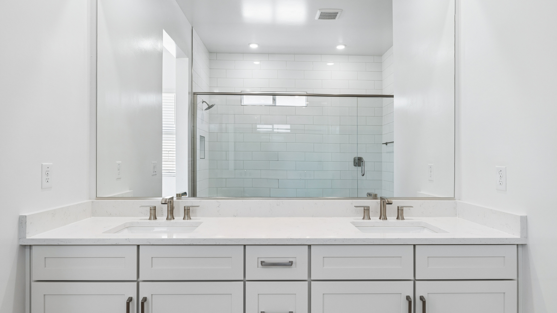 primary spa inspired bathroom with dual vanities and walk in shower