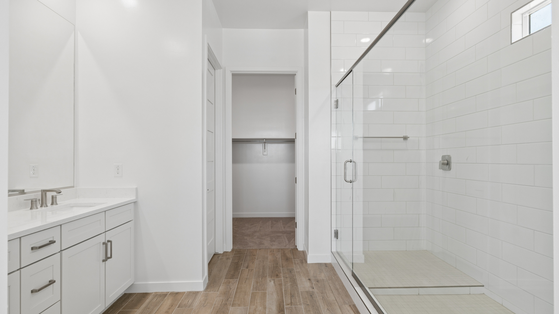 primary spa inspired bathroom with dual vanities and walk in shower