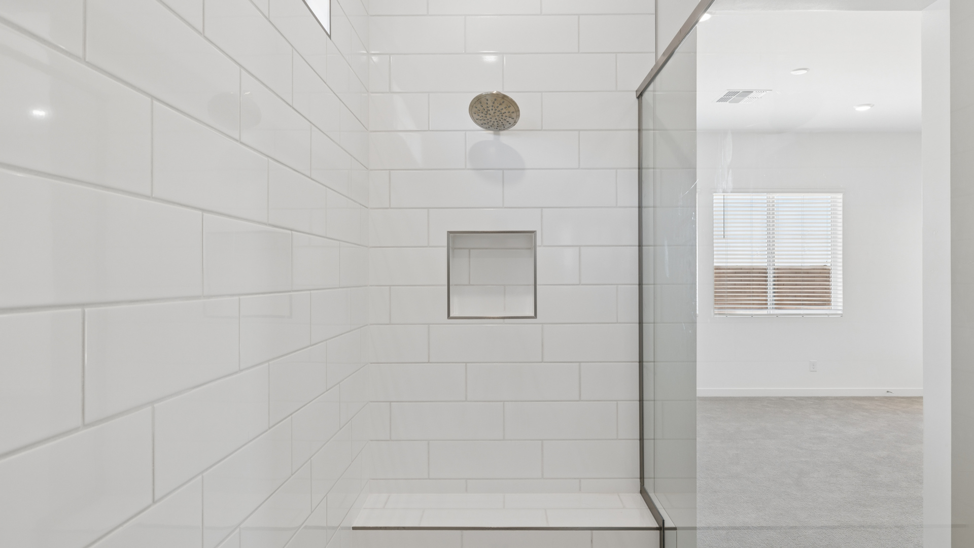 primary spa inspired bathroom with dual vanities and walk in shower