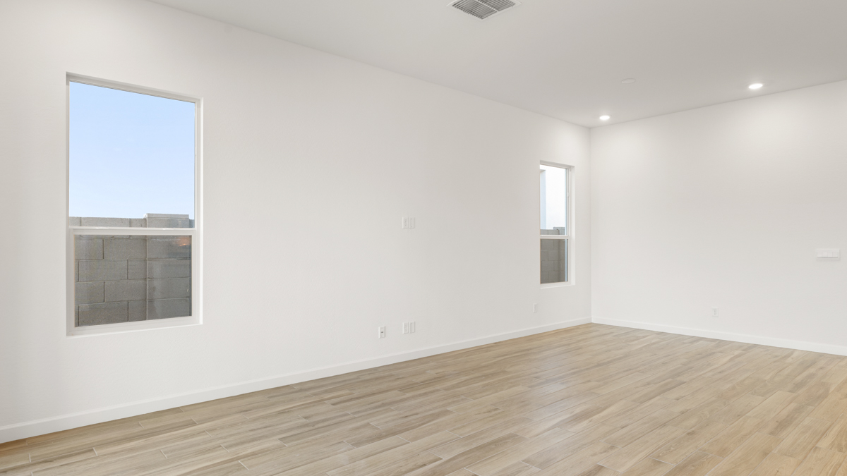 A well-organized living room that includes a kitchen and dining area, creating a warm and welcoming environment for gatherings.