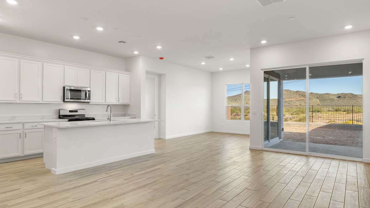 A well-organized living room that includes a kitchen and dining area, creating a warm and welcoming environment for gatherings.