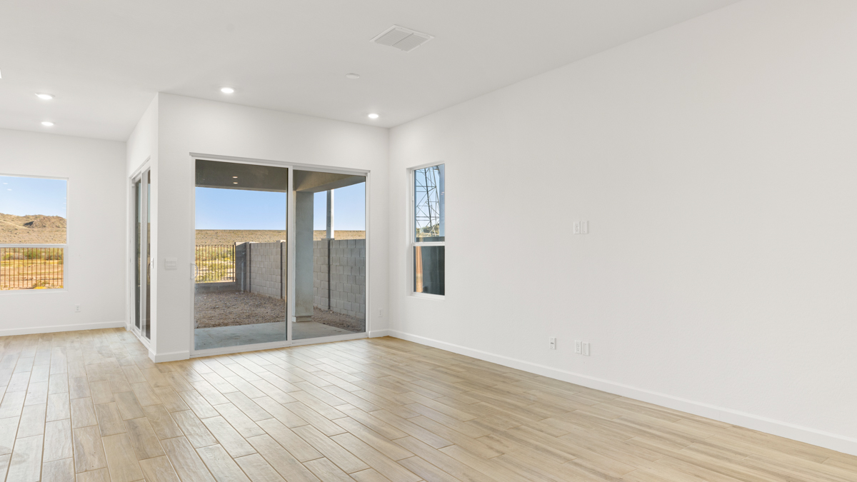 A well-organized living room that includes a kitchen and dining area, creating a warm and welcoming environment for gatherings.