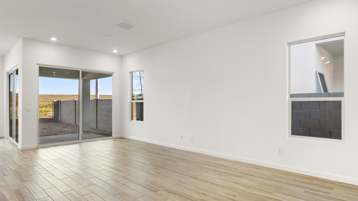 A well-organized living room that includes a kitchen and dining area, creating a warm and welcoming environment for gatherings.