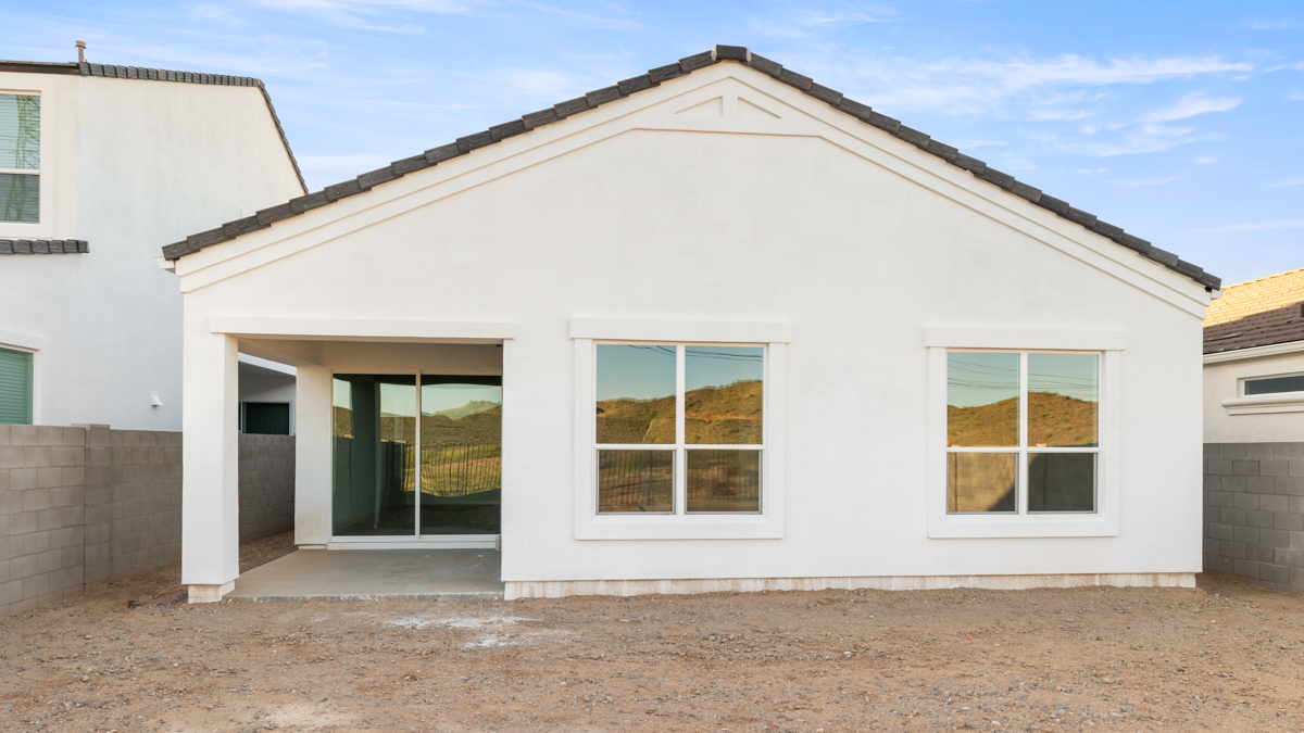 Large fenced-in backyard with a covered patio, perfect for outdoor entertaining.