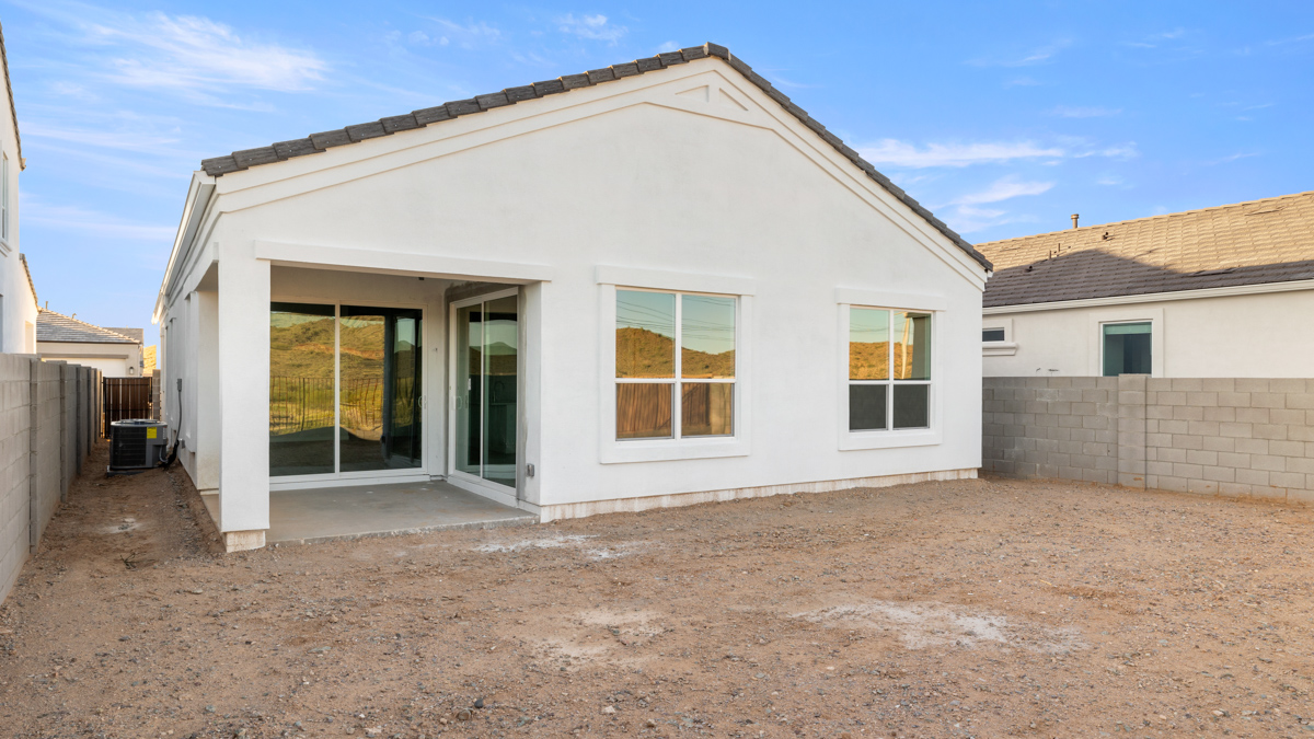 Large fenced-in backyard with a covered patio, perfect for outdoor entertaining.