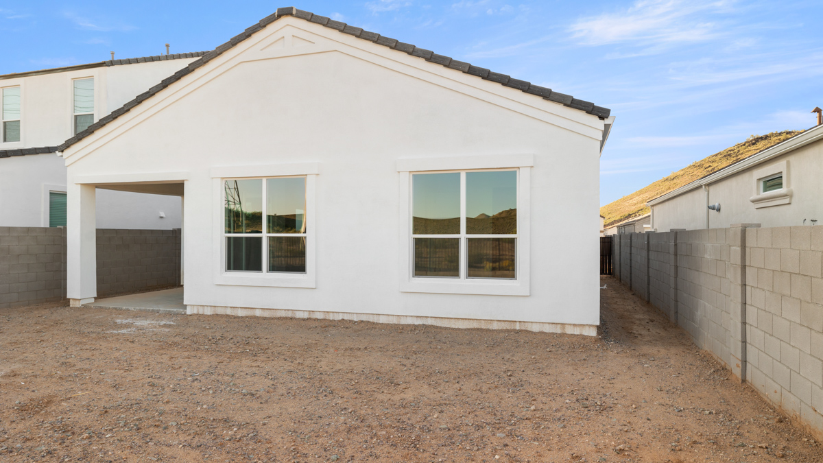 Large fenced-in backyard with a covered patio, perfect for outdoor entertaining.