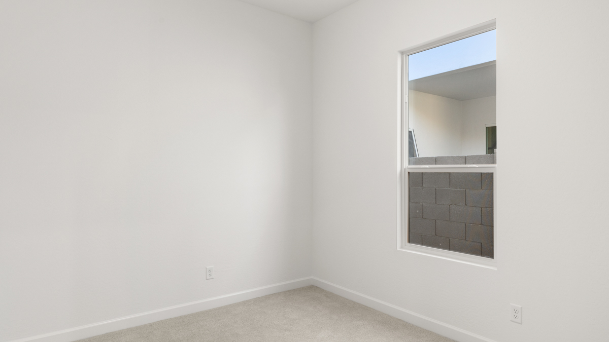Comfortable guest bedroom featuring neutral-toned walls and a large closet.