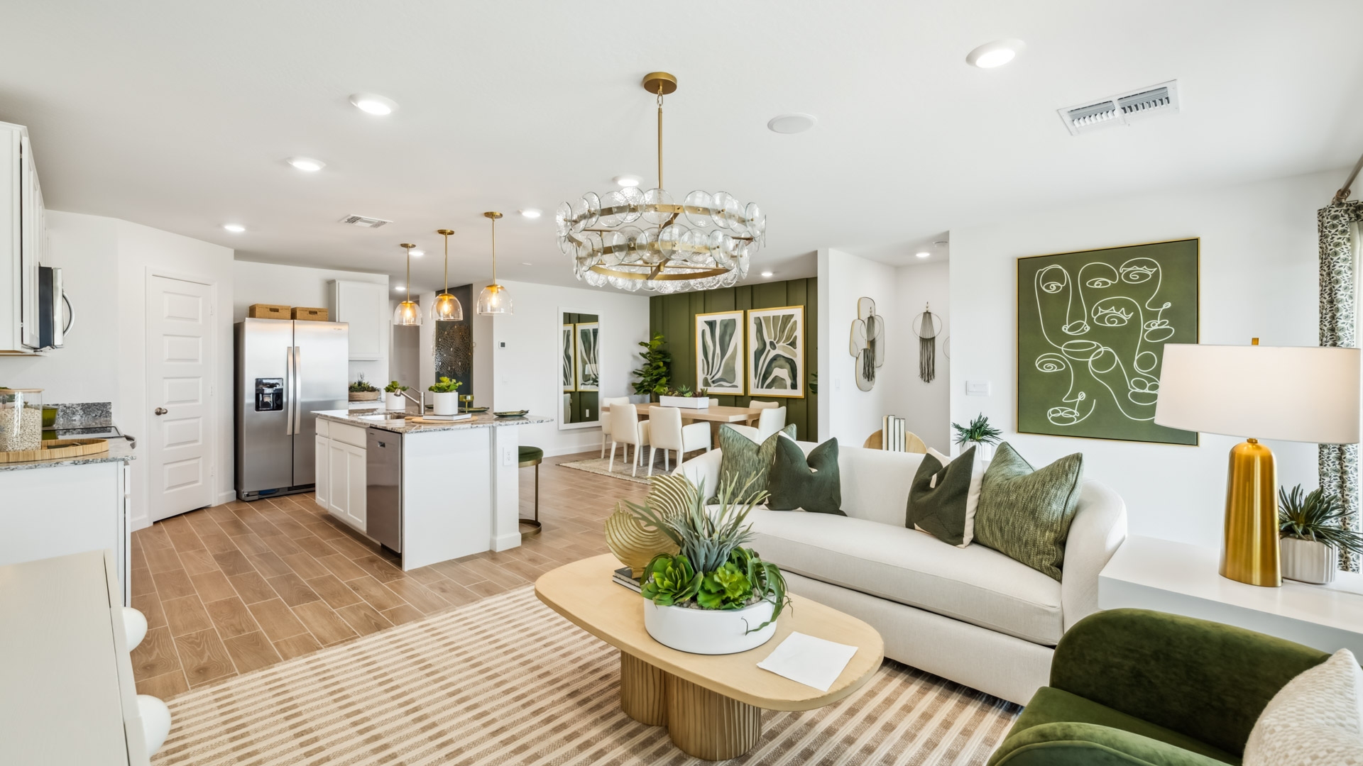 A well-organized living room that includes a kitchen and dining area, creating a warm and welcoming environment for gatherings.