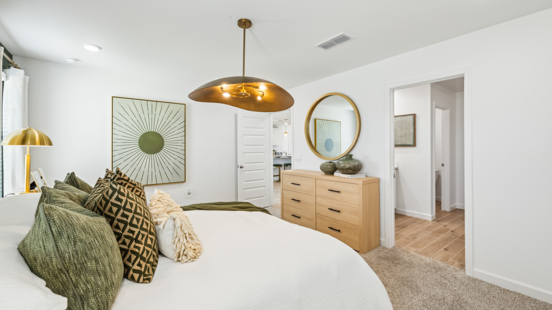 A spacious primary bedroom emphasizing open space and natural lighting.