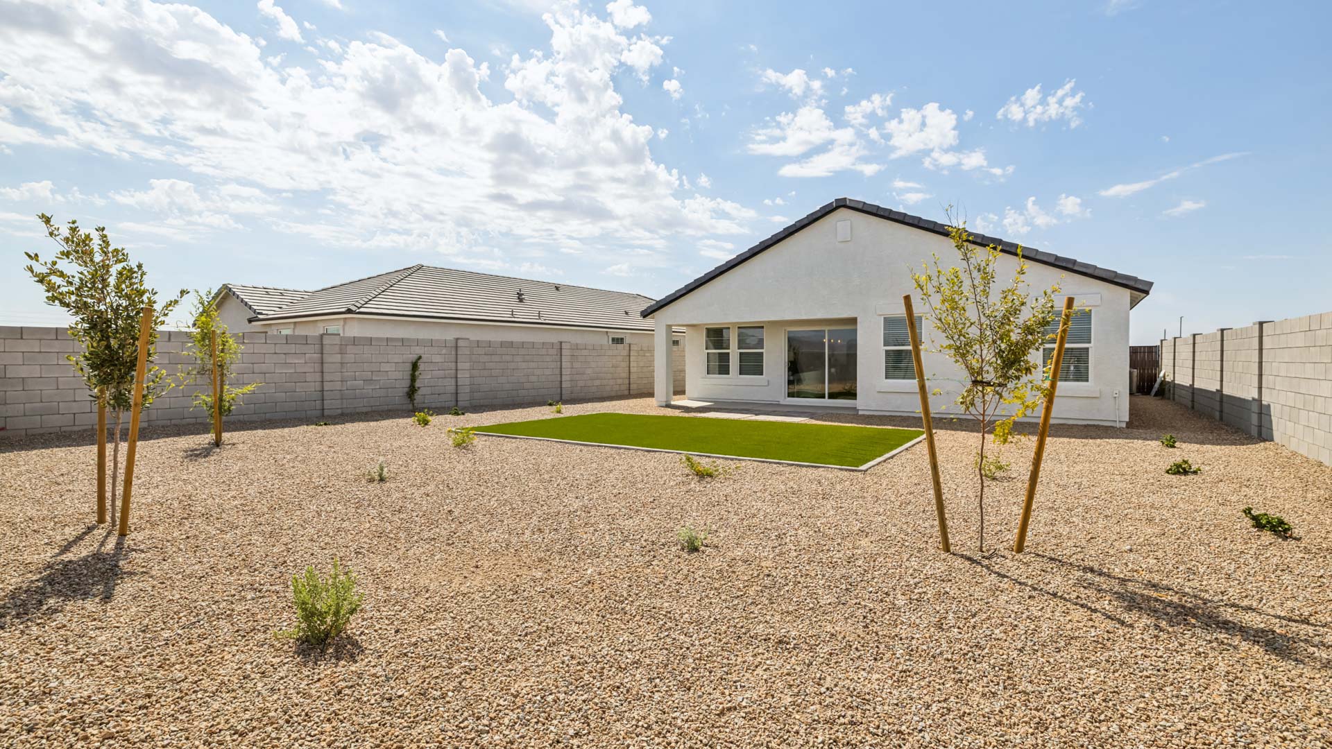 Large fenced-in backyard with a covered patio, perfect for outdoor entertaining.