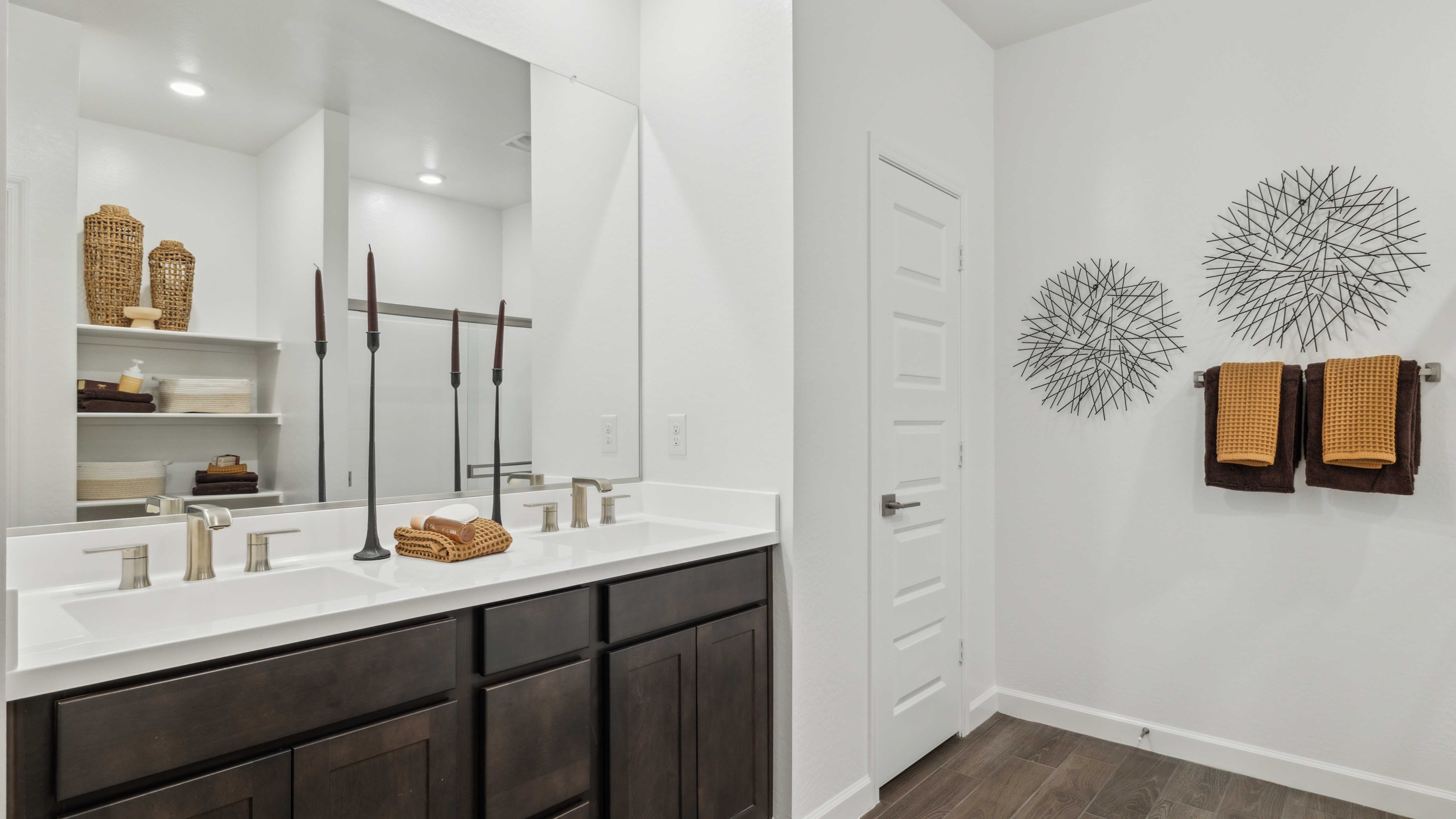 primary bathroom with dual vanities