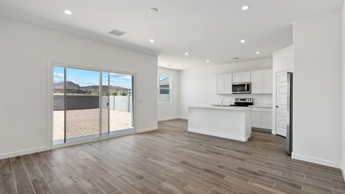 Central kitchen island designed to anchor the home with appliance suite included, sink, pantry, and multi-prep zones