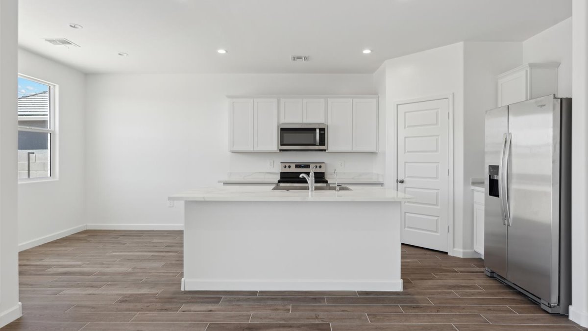 Island kitchen layout with new appliance suite included, storage, pantry, sink, and functional prep zones