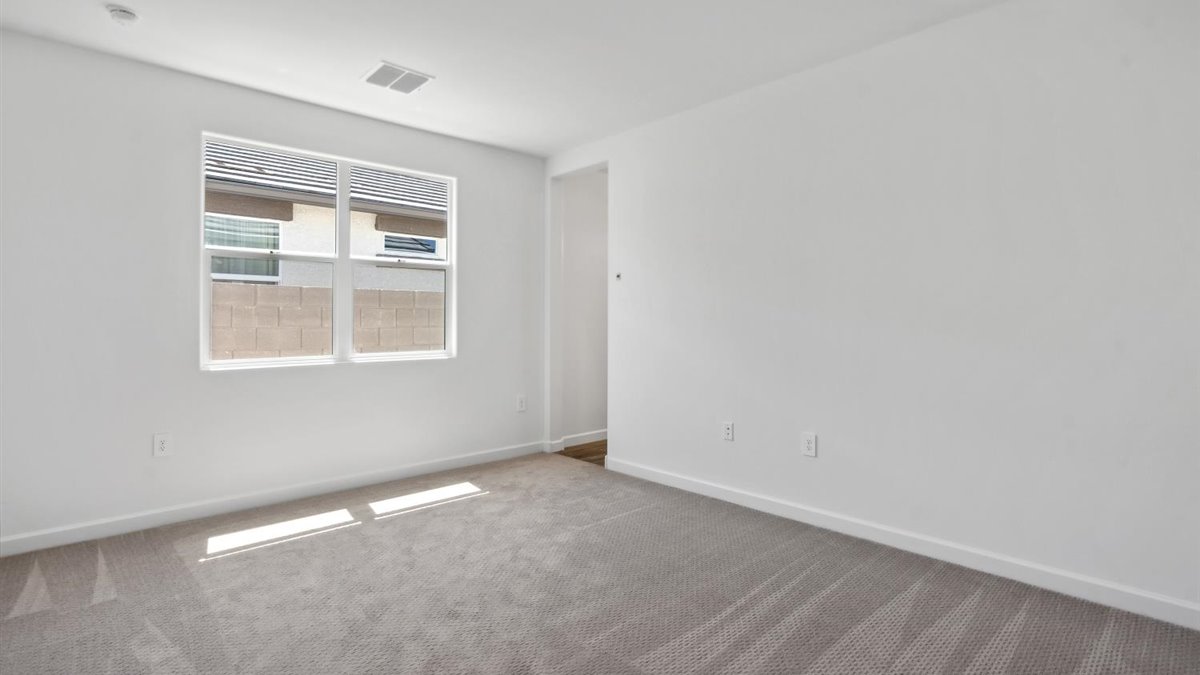 Primary bedroom features ample space, double windows, soft carpet, a stylish walk-in closet, and a private ensuite bath