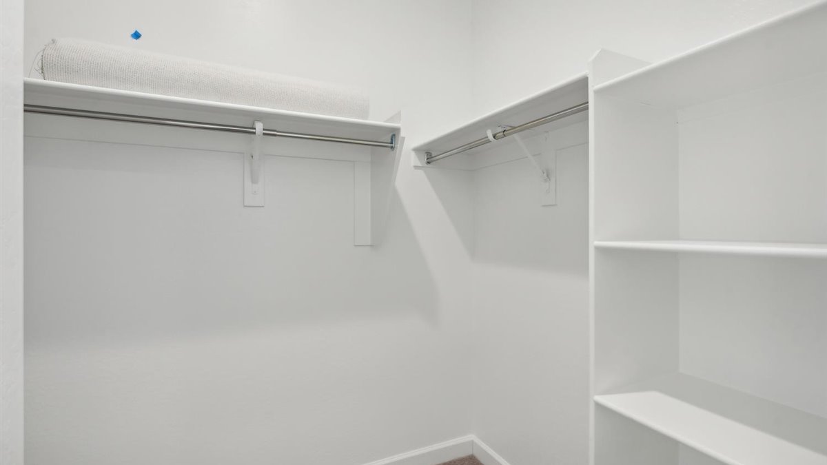 Interior view of the walk-in closet connected to the primary bedroom with spa-inspired ensuite and generous storage