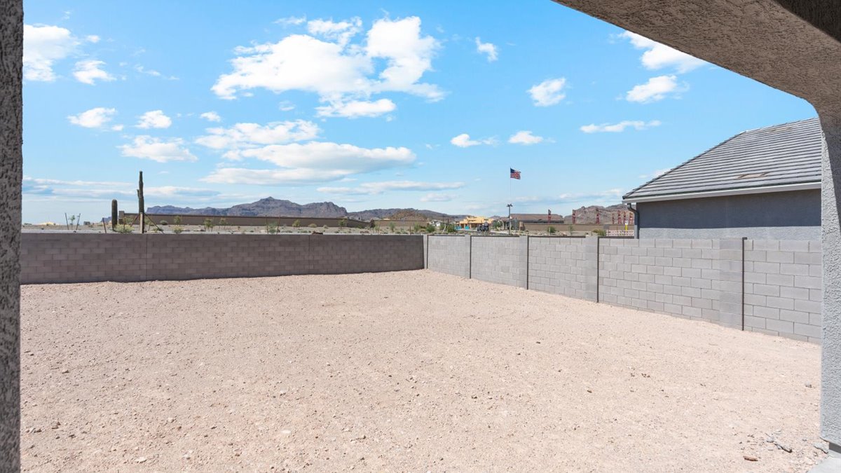 Backyard views featuring covered concrete patios with space for seating and grill setup