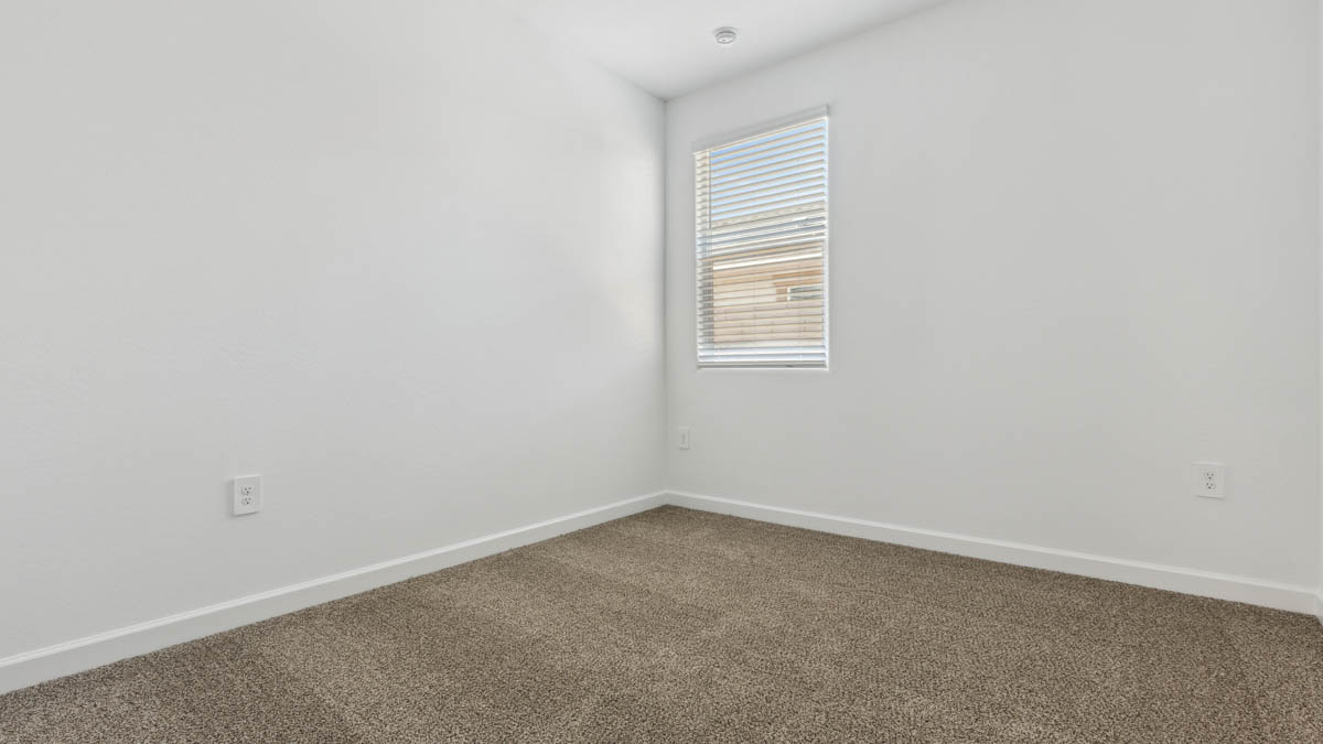 Comfortable guest bedroom featuring neutral-toned walls and a large closet.