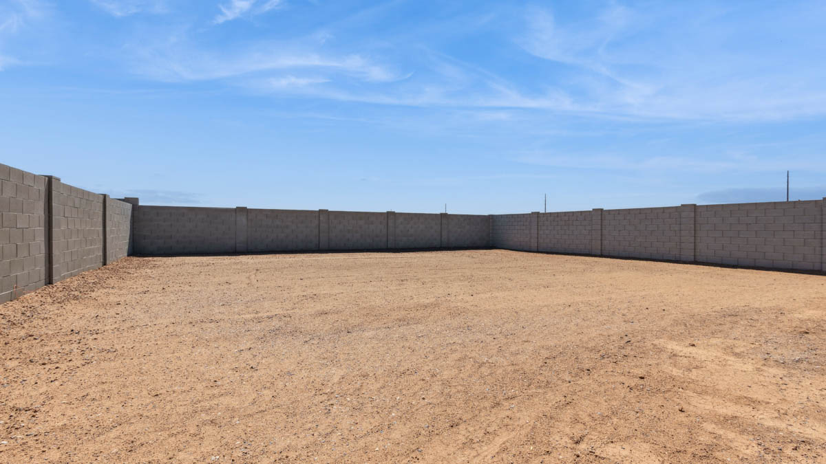 Large fenced-in backyard with a covered patio, perfect for outdoor entertaining.