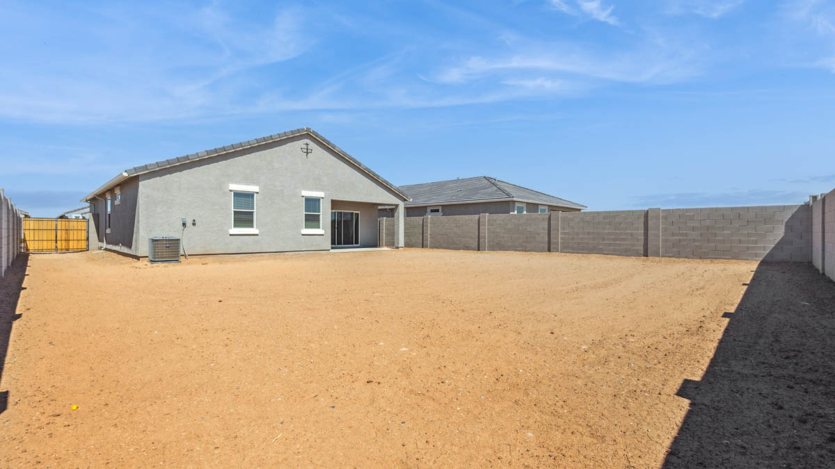 Large fenced-in backyard with a covered patio, perfect for outdoor entertaining.