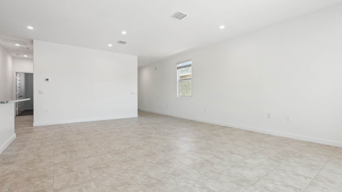 A well-organized living room that includes a kitchen and dining area, creating a warm and welcoming environment for gatherings.