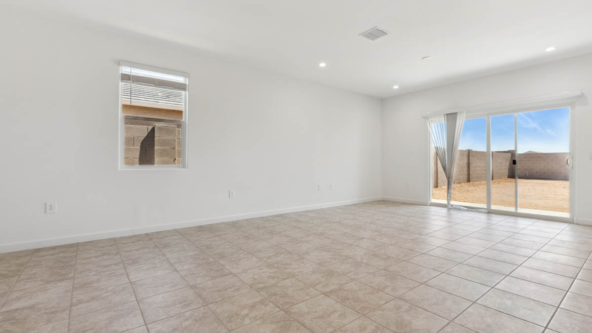 A well-organized living room that includes a kitchen and dining area, creating a warm and welcoming environment for gatherings.