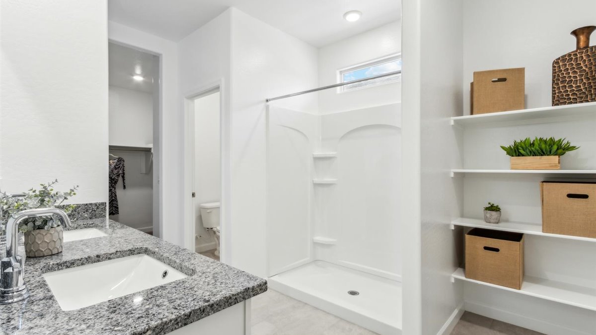 primary bathroom with dual vanities