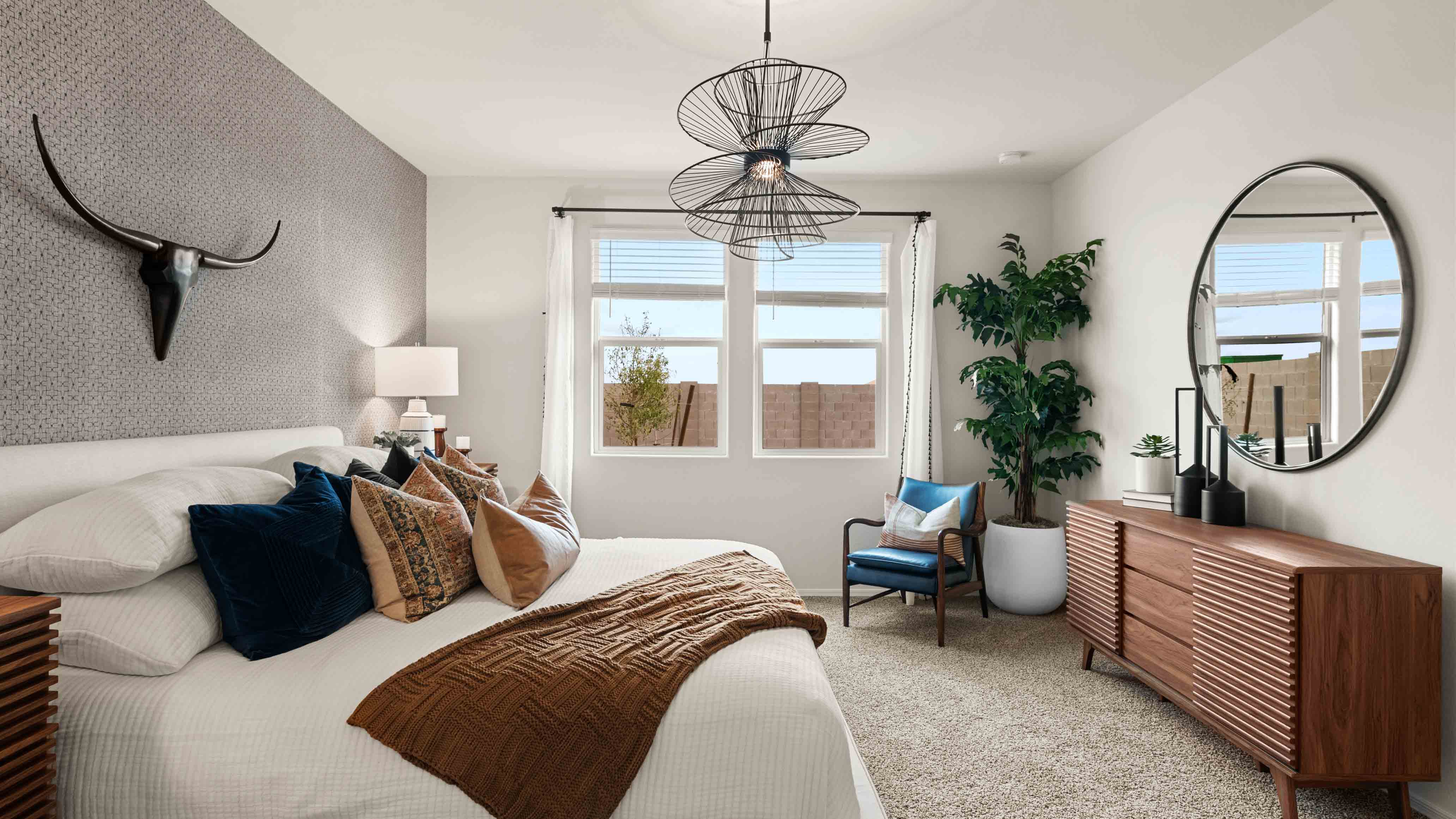 A spacious primary bedroom emphasizing open space and natural lighting.