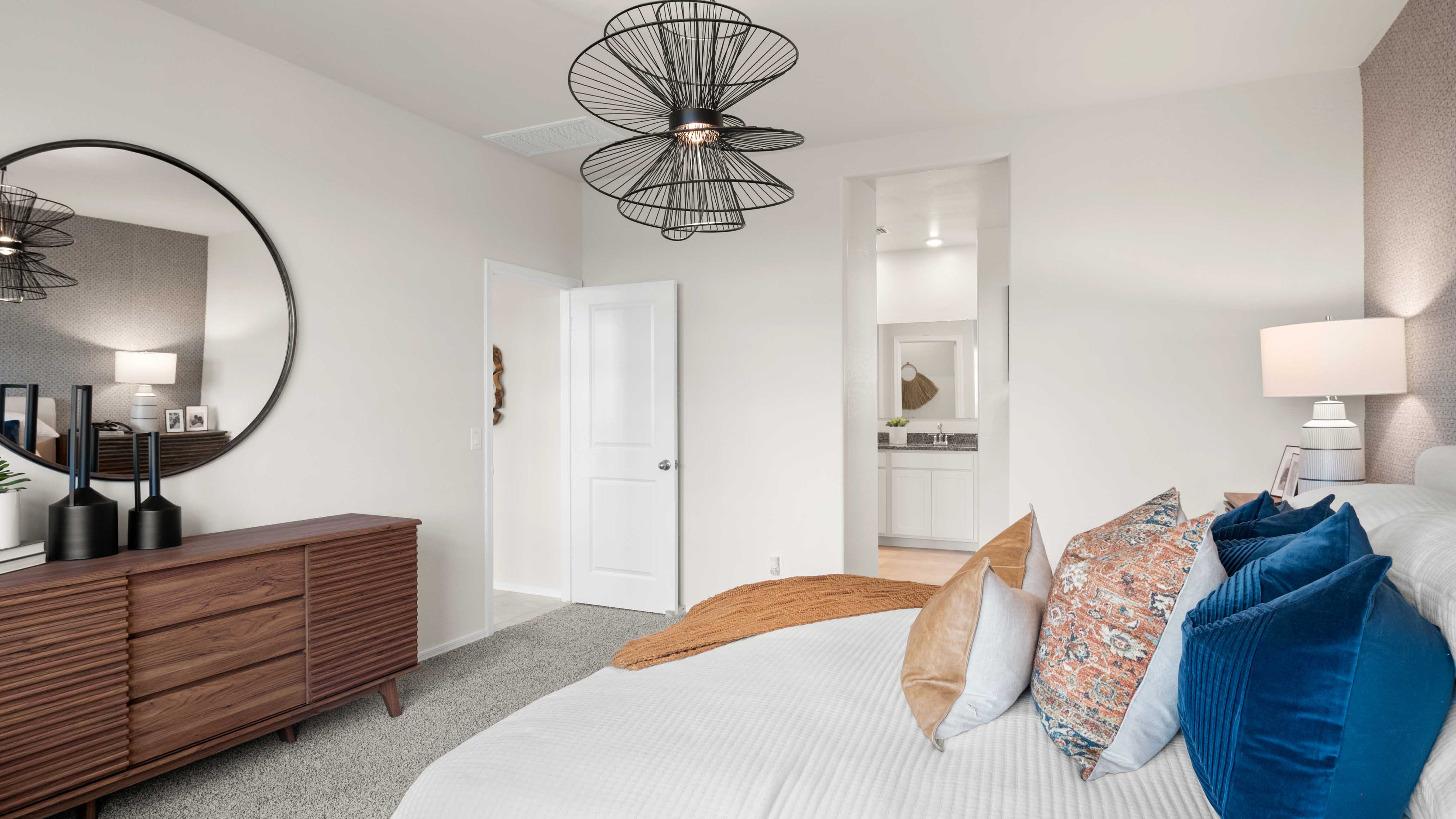 A spacious primary bedroom emphasizing open space and natural lighting.