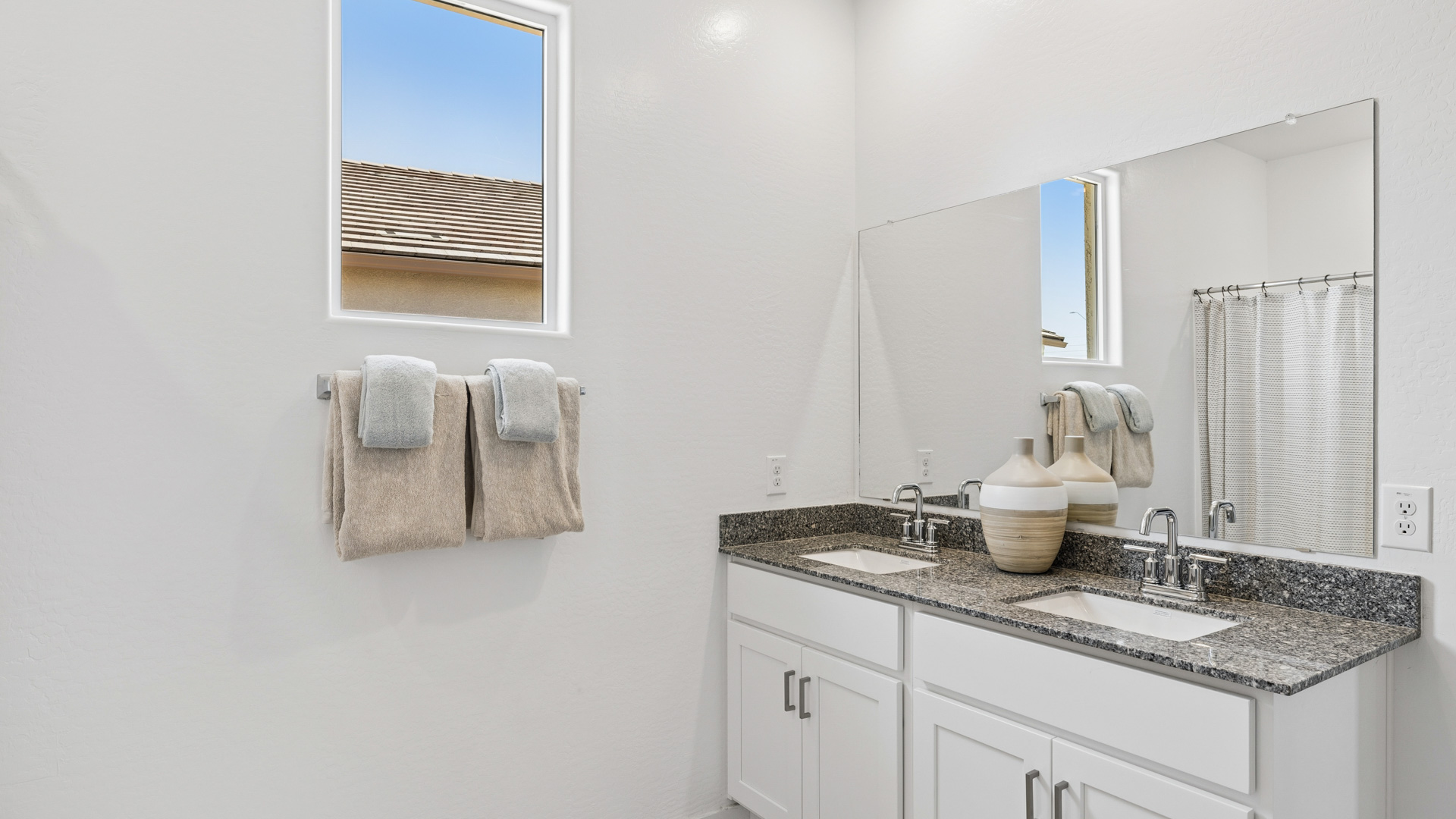 primary bathroom with dual vanities