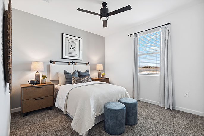 Comfortable guest bedroom featuring neutral-toned walls, carpeted flooring, and a large closet.