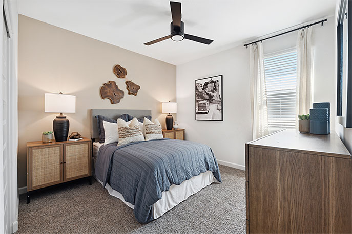 Comfortable guest bedroom featuring neutral-toned walls, carpeted flooring, and a large closet.
