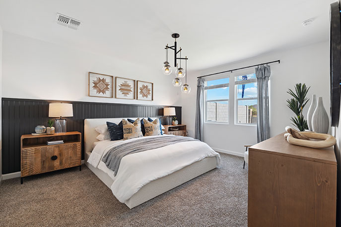 Primary bedroom with plush carpeting and a large walk-in closet.