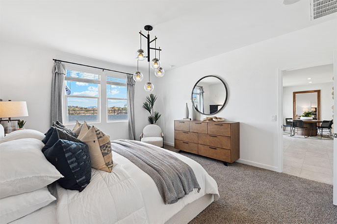 Primary bedroom with plush carpeting and a large walk-in closet.