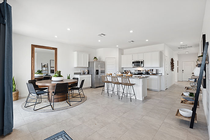 A well-organized living room that includes a kitchen and dining area, creating a warm and welcoming environment for gatherings.