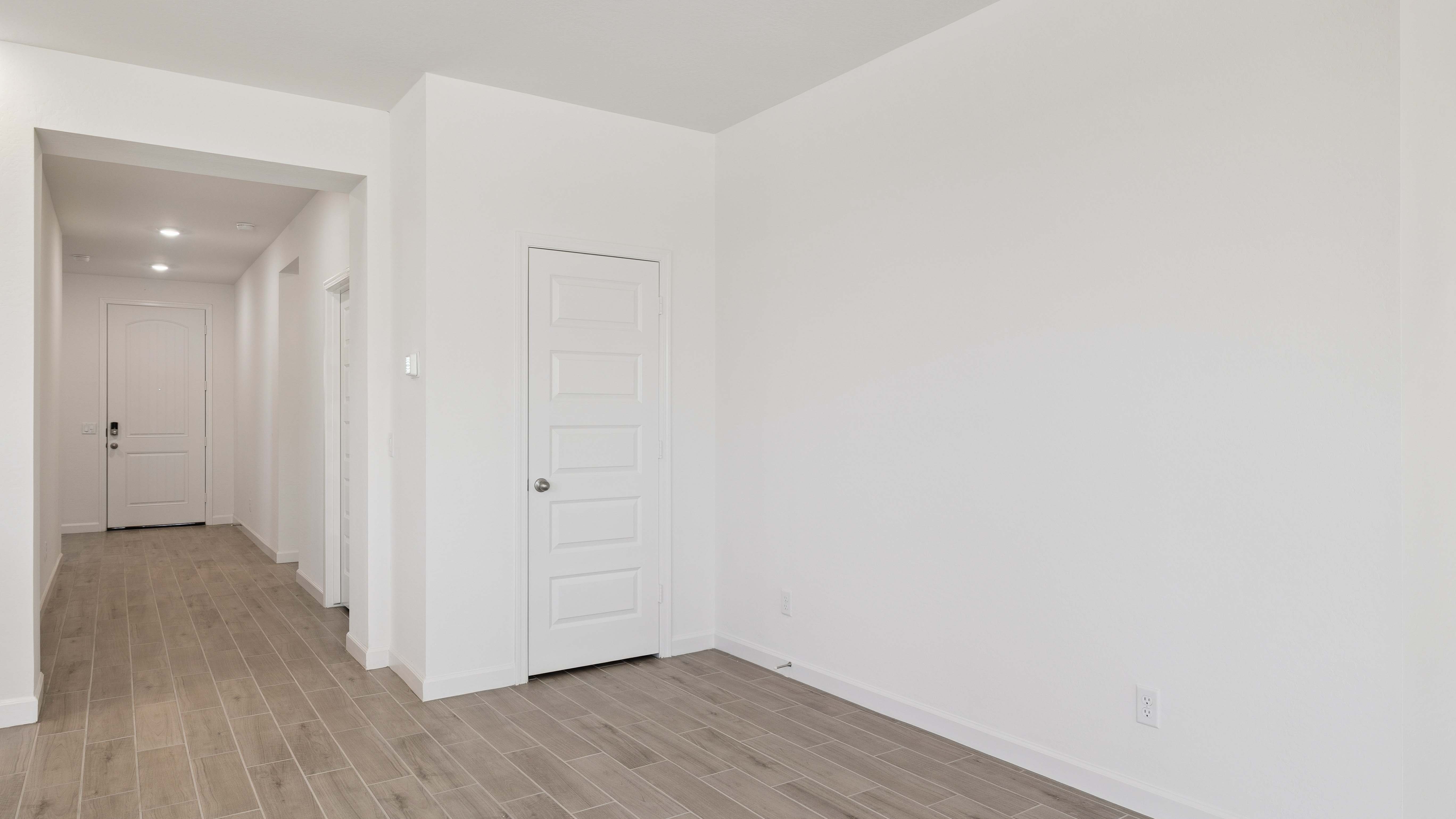 Entry hallway leading to bedrooms in the background.
