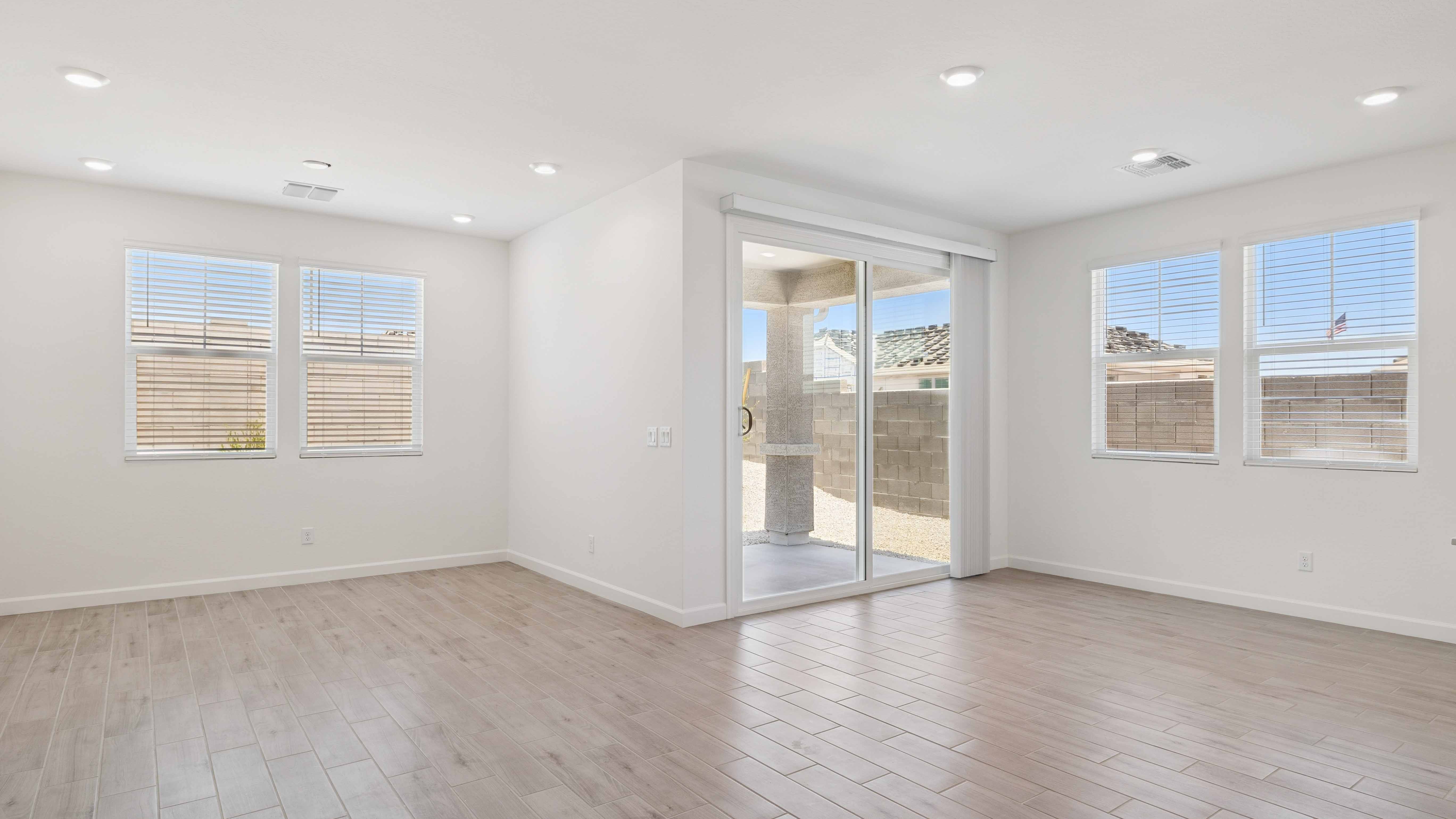 A well-organized living room that includes a kitchen and dining area, creating a warm and welcoming environment for gatherings.