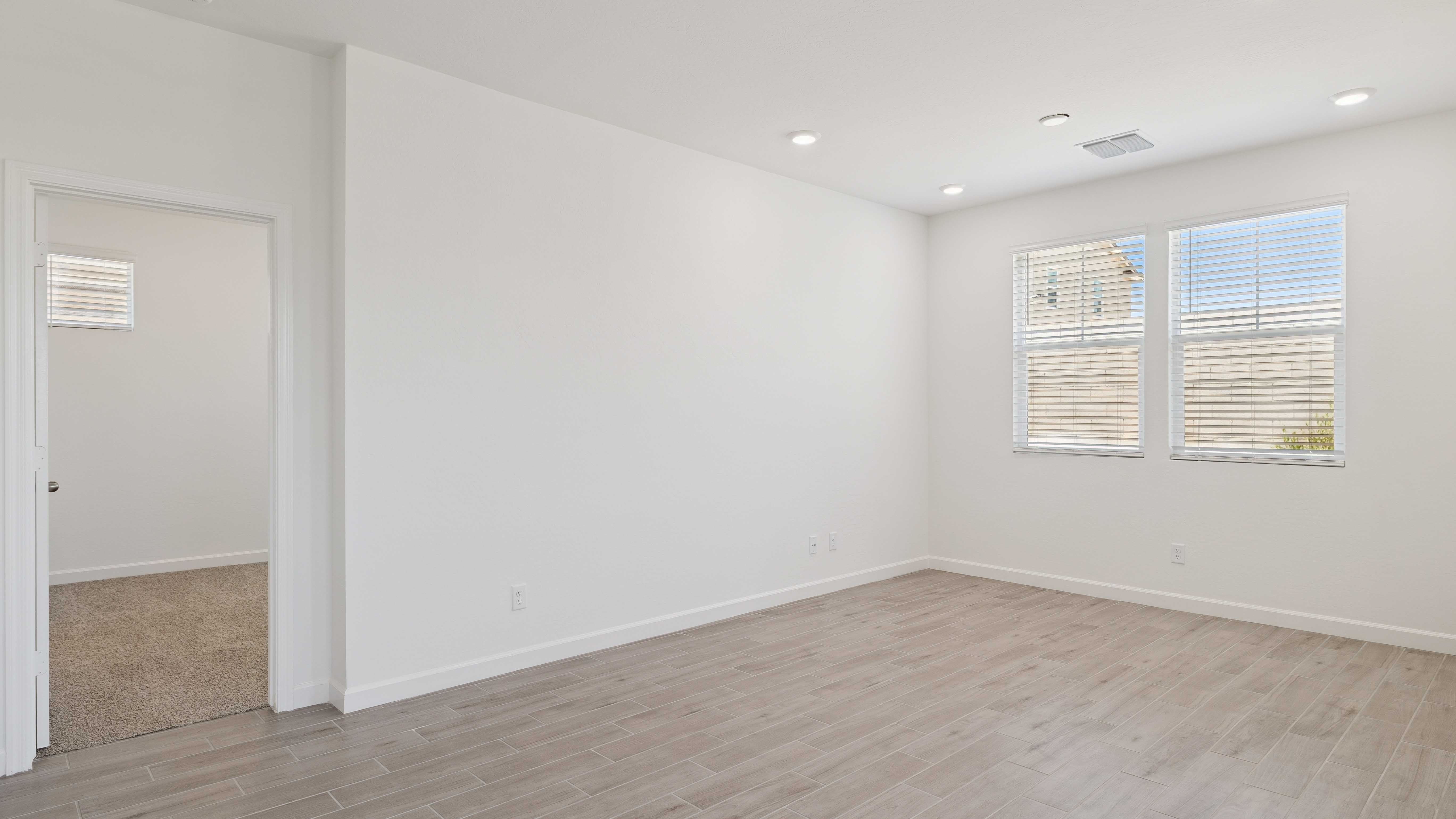 A well-organized living room that includes a kitchen and dining area, creating a warm and welcoming environment for gatherings.