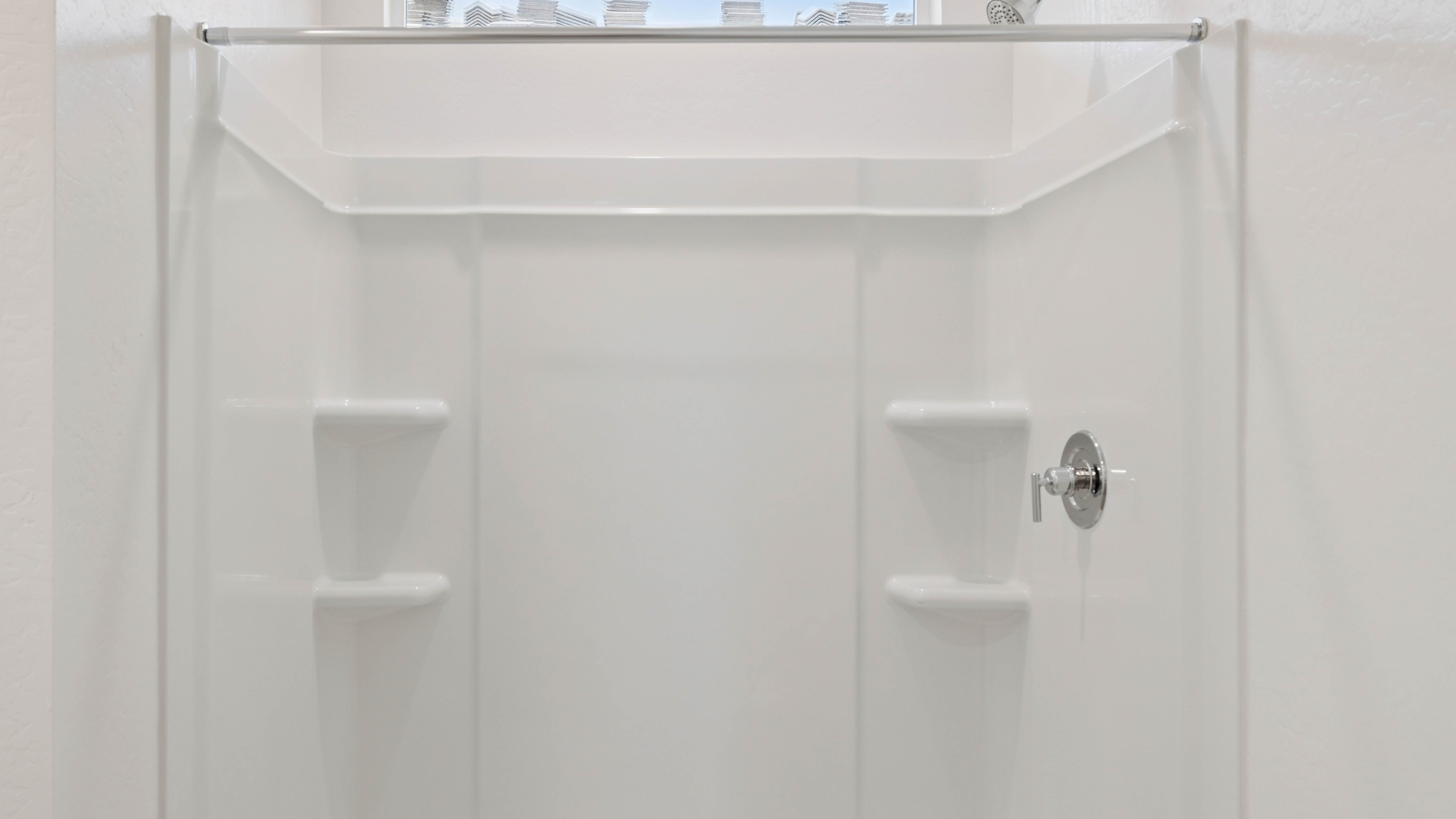 Modern primary bathroom with double vanities, quartz countertops with a walk-in shower and a walk-in closet.
